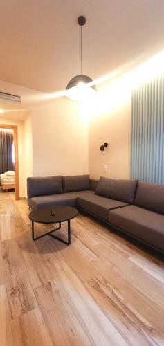 a living room with a couch and a coffee table at Central in Georgioupolis