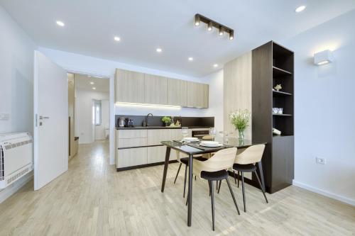 a kitchen and dining room with a table and chairs at Sidra city apartment in Zadar