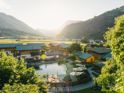 an aerial view of a village with a river at Feelfree Nature Resort in Oetz