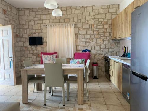 a kitchen and dining room with a table and chairs at Deep Blue Villas in Vasilikos