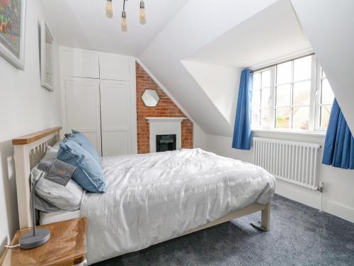 a bedroom with a bed and a window at The Apothecary in Brockenhurst
