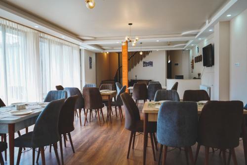 a conference room with tables and chairs and a television at ALOFT in Stepantsminda