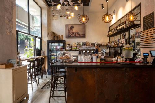 a bar in a restaurant with bar stools at Assemblage Boutique in Tel Aviv
