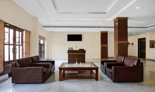 a living room with two couches and a coffee table at Treebo Trend Little Budhha in Varanasi