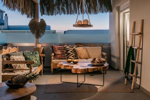 a living room with a couch and a table at Khroma Luxury Suite 2 Beach front apartment in Hersonissos