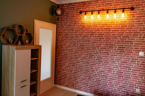 a brick wall with a shelf and lights on it at Home Away From Home in Perea