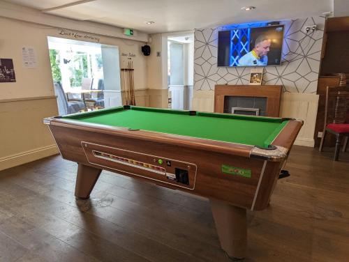 a pool table in a living room with a tv at Barley Sheaf, Old Bridge Street EN SUITE ROOMS, ROOM ONLY in Truro