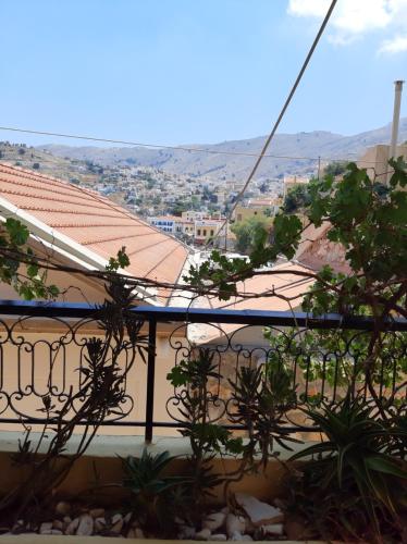a view from the balcony of a building with plants at Marina Studios in Symi