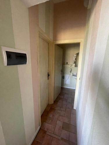 an empty hallway with a door and a tile floor at Borgo Romena in Pratovecchio