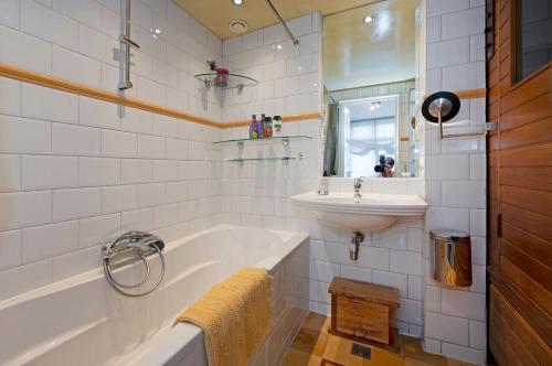a bathroom with a tub and a sink at Waalstraat 89-2 in Amsterdam