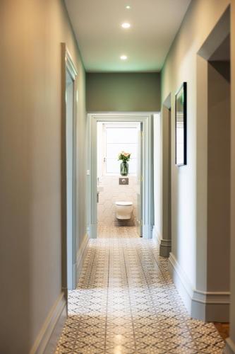a hallway with a toilet in a bathroom at Magmell Townhouse in Baltinglass