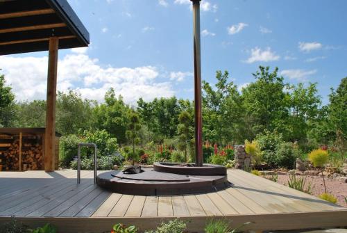 a wooden deck with a pavilion in a garden at Peaceful Bothy Retreat in Nairn