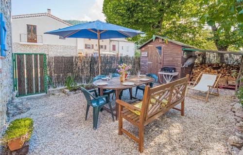 a patio with a table and chairs and an umbrella at Stunning Home In Andon With Kitchen in Andon