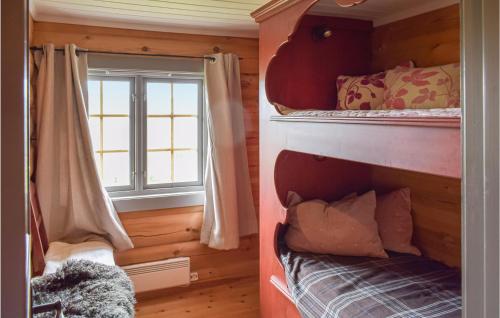two bunk beds in a room with a window at Beautiful Home In Uvdal With 3 Bedrooms And Sauna in Uvdal