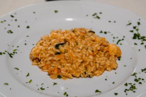 a plate of food with rice on a table at Hotel Ariston and Palazzo Santa Caterina in Taormina