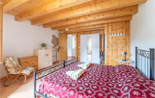 a bedroom with a large bed and a wooden ceiling at Casa Sant in SantʼAnna dʼAlfaedo