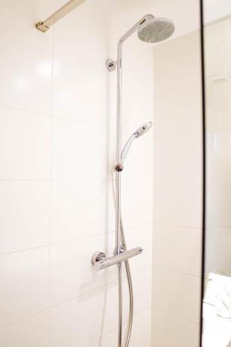 a shower with a glass door in a bathroom at Hotel Gravensteen in Ghent