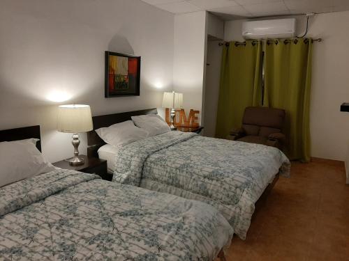 מיטה או מיטות בחדר ב-Bienvenidos a Guararé