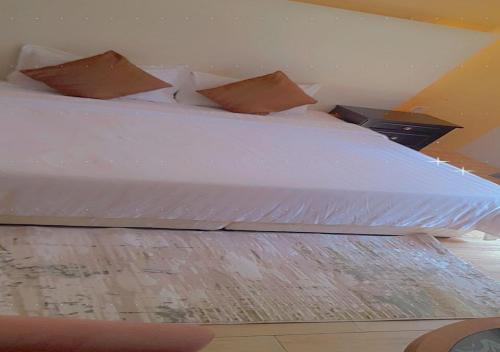 a bed with white sheets and pillows in a room at ميرا سويت للشقق المخدومة in Jeddah