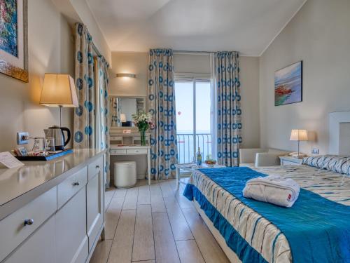 a bedroom with a bed and a bathroom at Hotel Ariston and Palazzo Santa Caterina in Taormina