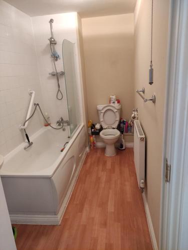 a bathroom with a bath tub and a toilet at Immaculate 1-Bed Apartment in Borehamwood in Borehamwood