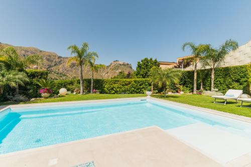 a swimming pool in the backyard of a house at Villa Mastrissa Taormina in Taormina
