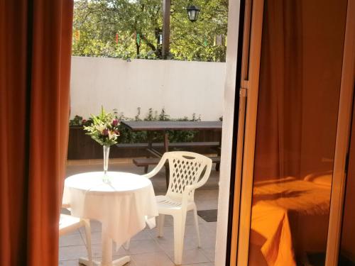 a room with a table and two chairs and a table and a window at Pansion Chrisa in Skiathos Town