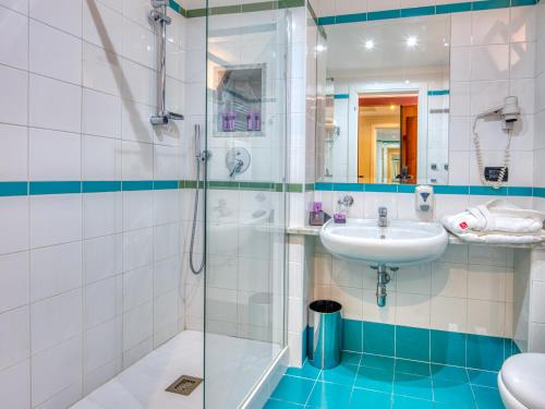 a bathroom with a sink and a shower at Hotel Ariston and Palazzo Santa Caterina in Taormina