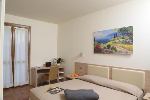 Postel nebo postele na pokoji v ubytování Appartamenti Corte Leonardo