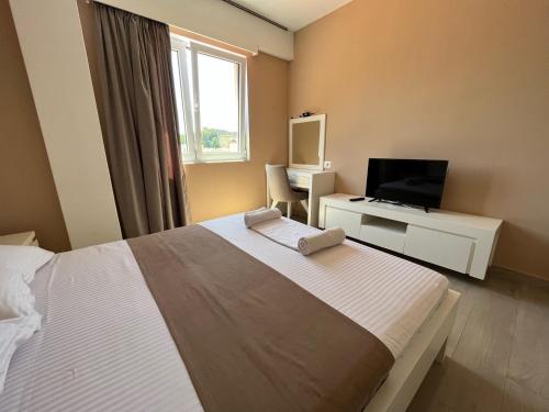 a bedroom with a bed and a desk with a computer at Bella Vista B&B in Ulcinj
