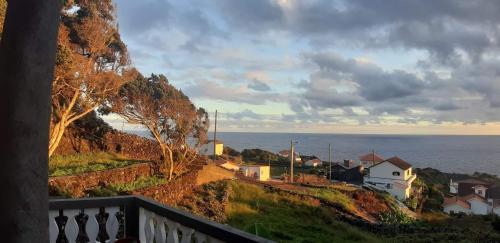 a view of the ocean from a balcony at Adega do Golfinho in Feiteira