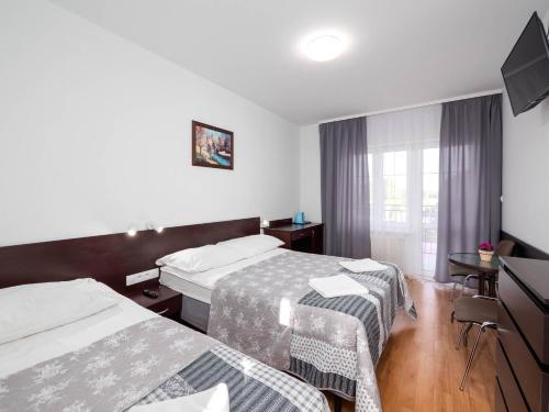 Postel nebo postele na pokoji v ubytování Astoria