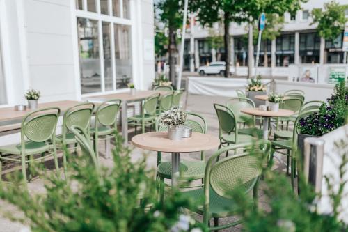 a row of tables and chairs on a city street at Best Western Hotel Kurfürst Wilhelm I. in Kassel