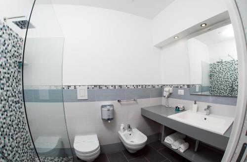 a bathroom with a sink and a toilet and a shower at B&B Diana in Piazza Armerina