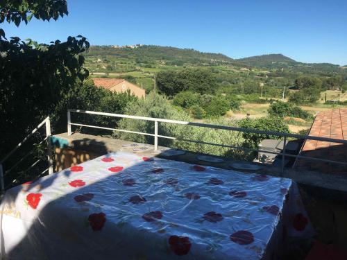 a bed on a balcony with a view at À l'ombre du mûrier in Blauvac