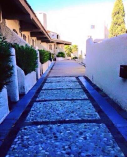 a sidewalk with blue lights next to a building at Petit Cocon magnifique vue sur Marina dans le golfe de Saint Tropez in Cogolin