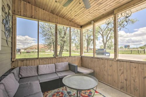 a screened in porch with a couch and a table at Idyllic Gem Screened Porch, half Mi to River! in Thermopolis