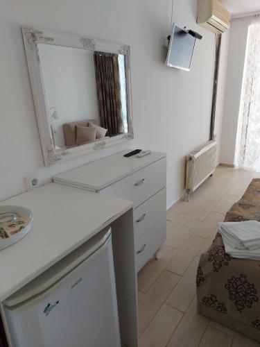 a bathroom with a white dresser and a mirror at хотел Кристиан in Sozopol