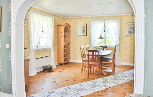 a dining room with a table and chairs at Cozy Home In Lesjöfors With Kitchen in Lesjöfors