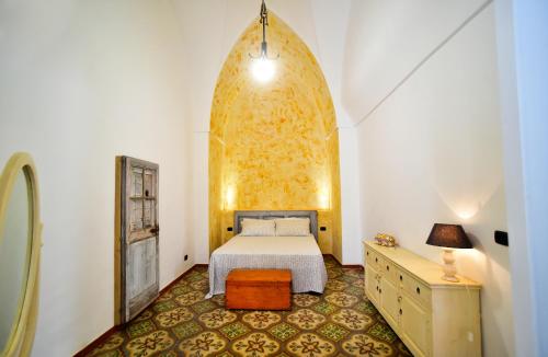 a bedroom with a bed and a dresser in it at Le case di Via Patitari in Gallipoli