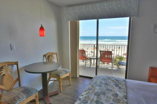 a bedroom with a bed and a view of the ocean at Daytona Dream Inn By AmeriVu in Daytona Beach