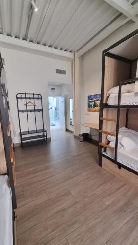 a room with two bunk beds and a wooden floor at Hostel Nut in Granada