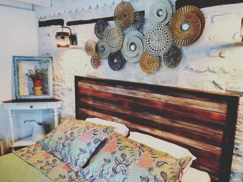 a bedroom with a bed and hats on the wall at La Fontenelle Chambres d'Hôtes in Sainte-Sévère