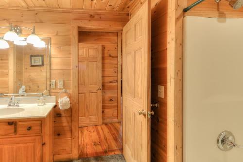 a bathroom with a sink and a mirror at RiverStone Condo Resort & Spa in Pigeon Forge