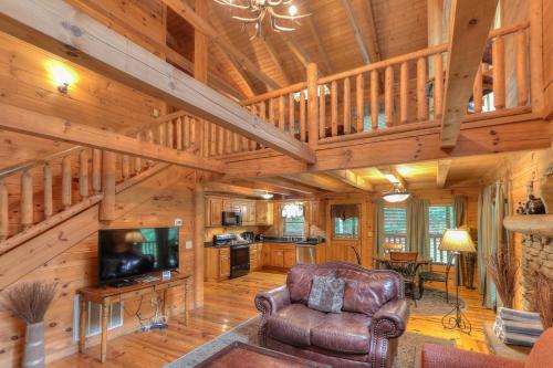 a living room with a couch and a television in a cabin at RiverStone Condo Resort & Spa in Pigeon Forge