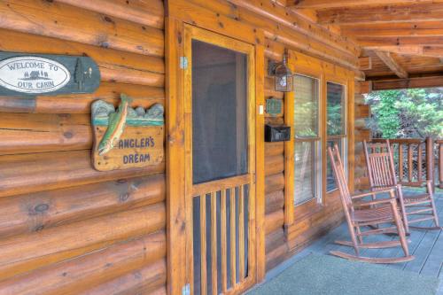 a front door of a log cabin with two chairs at RiverStone Condo Resort & Spa in Pigeon Forge