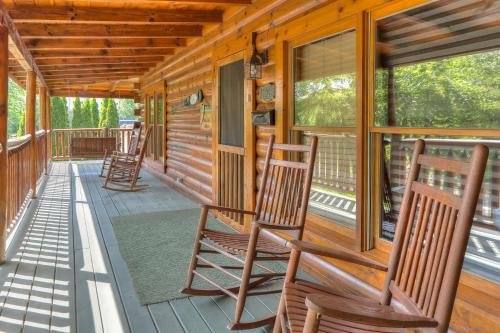 a porch with rocking chairs on a cabin at RiverStone Condo Resort & Spa in Pigeon Forge