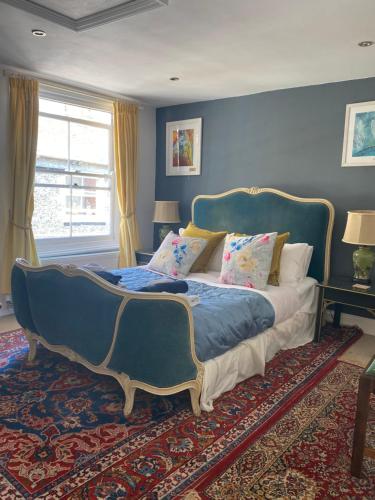 a bedroom with a large bed with a blue wall at King Street Accomadation in Margate