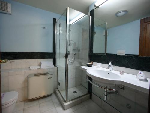 a bathroom with a shower and a sink and a toilet at Casa Dei Mercanti Town House in Lecce