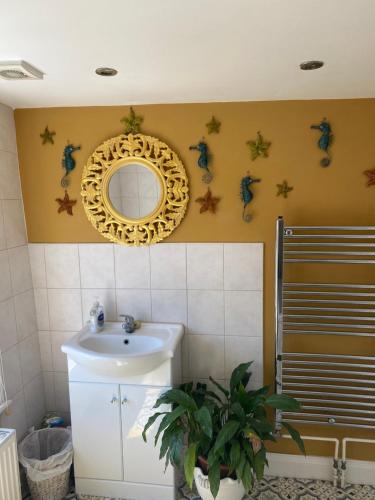 a bathroom with a sink and a mirror on the wall at King Street Accomadation in Margate